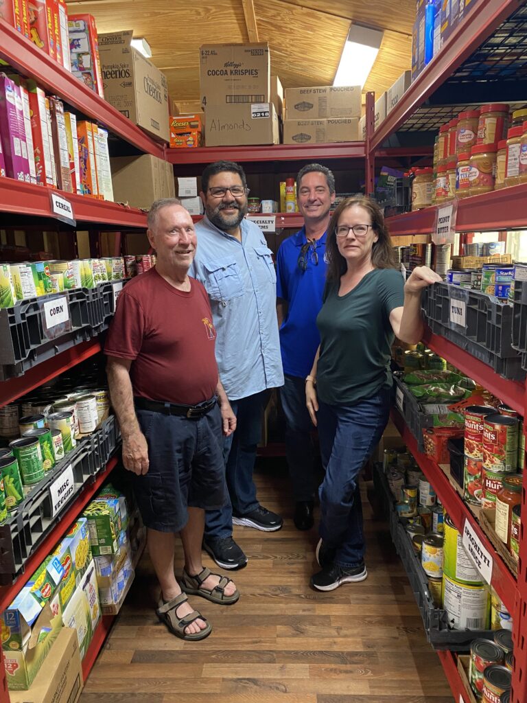 photo inside our food pantry with Joe Beach, Great Oaks Fellowship Executive Director Pastor Rob Viera, Jonathan Bush, and Christina Bush